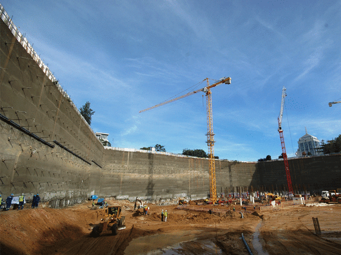 Earth retention comprising of soldier piles, strand anchors, rock bolts and gunite walls at discovery building